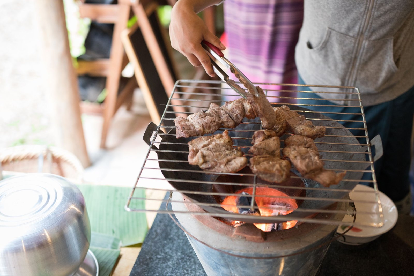 A hibachi chef in Santa Rosa Beach FL preparing food on a grill for a private at home dining experience