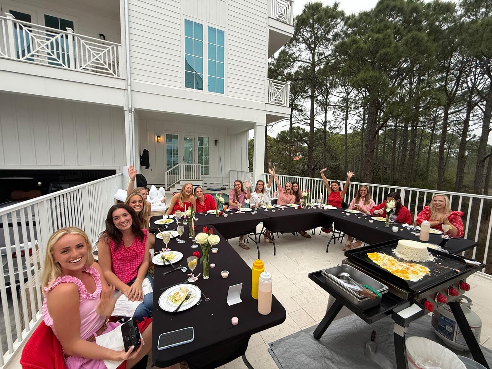 Guests enjoying live hibachi cooking at a luxury beach house along Florida’s Emerald Coast.