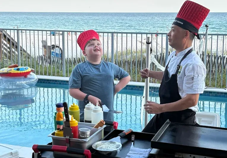 A private hibachi chef prepares fresh meals for guests at a luxury vacation rental near Destin.