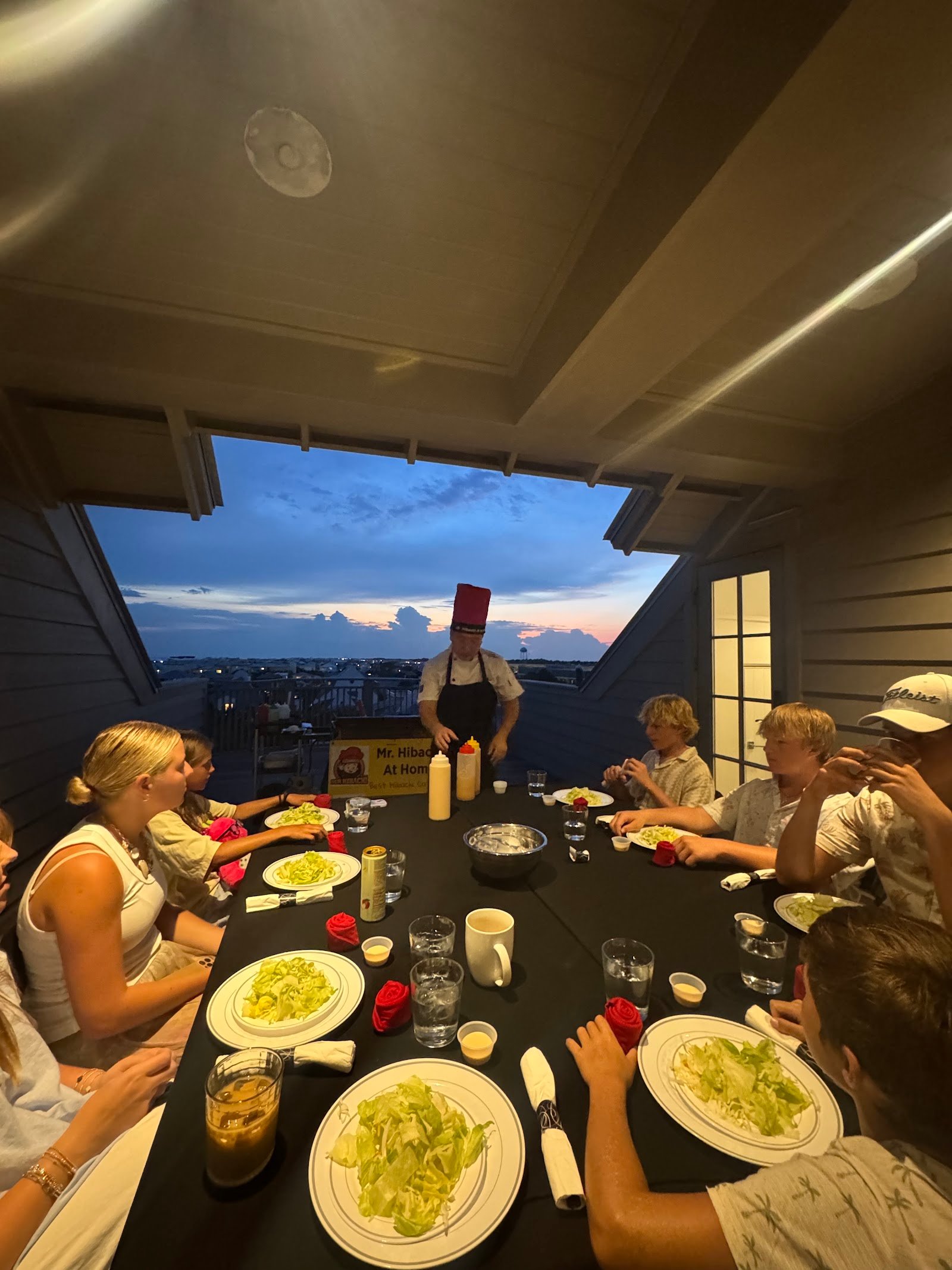 Extended family enjoying a rooftop hibachi dinner together in Fort Walton Beach
