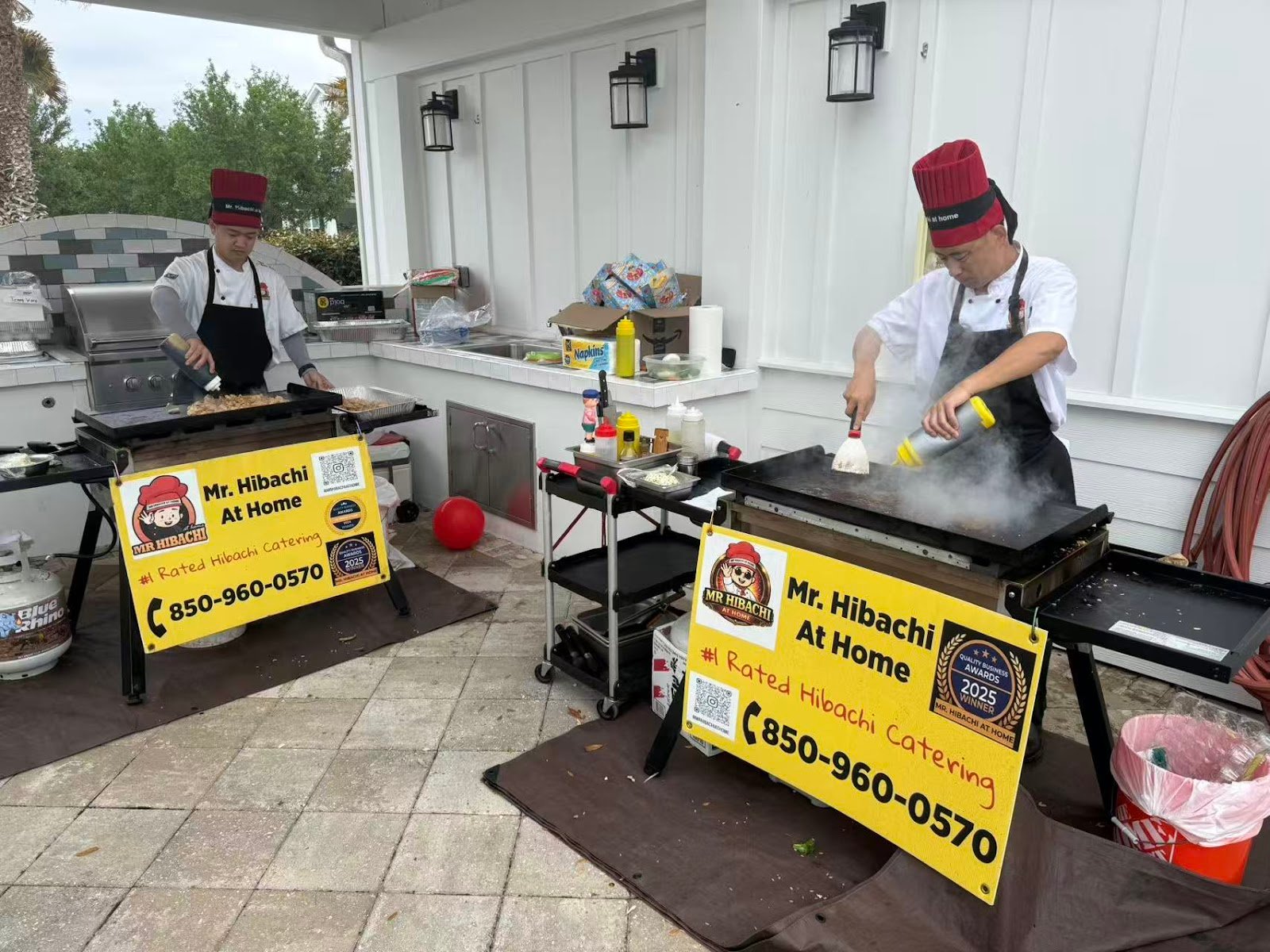 Two mobile hibachi grill stations set up for large group catering on Florida's Emerald Coast