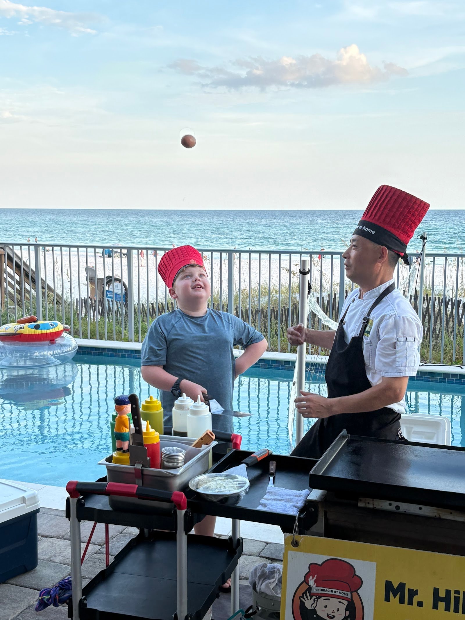 Private hibachi chef entertaining a child during a family reunion catering event in Navarre, FL