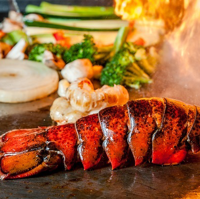 Flame-grilled lobster tail cooked hibachi-style for a romantic dinner on 30A