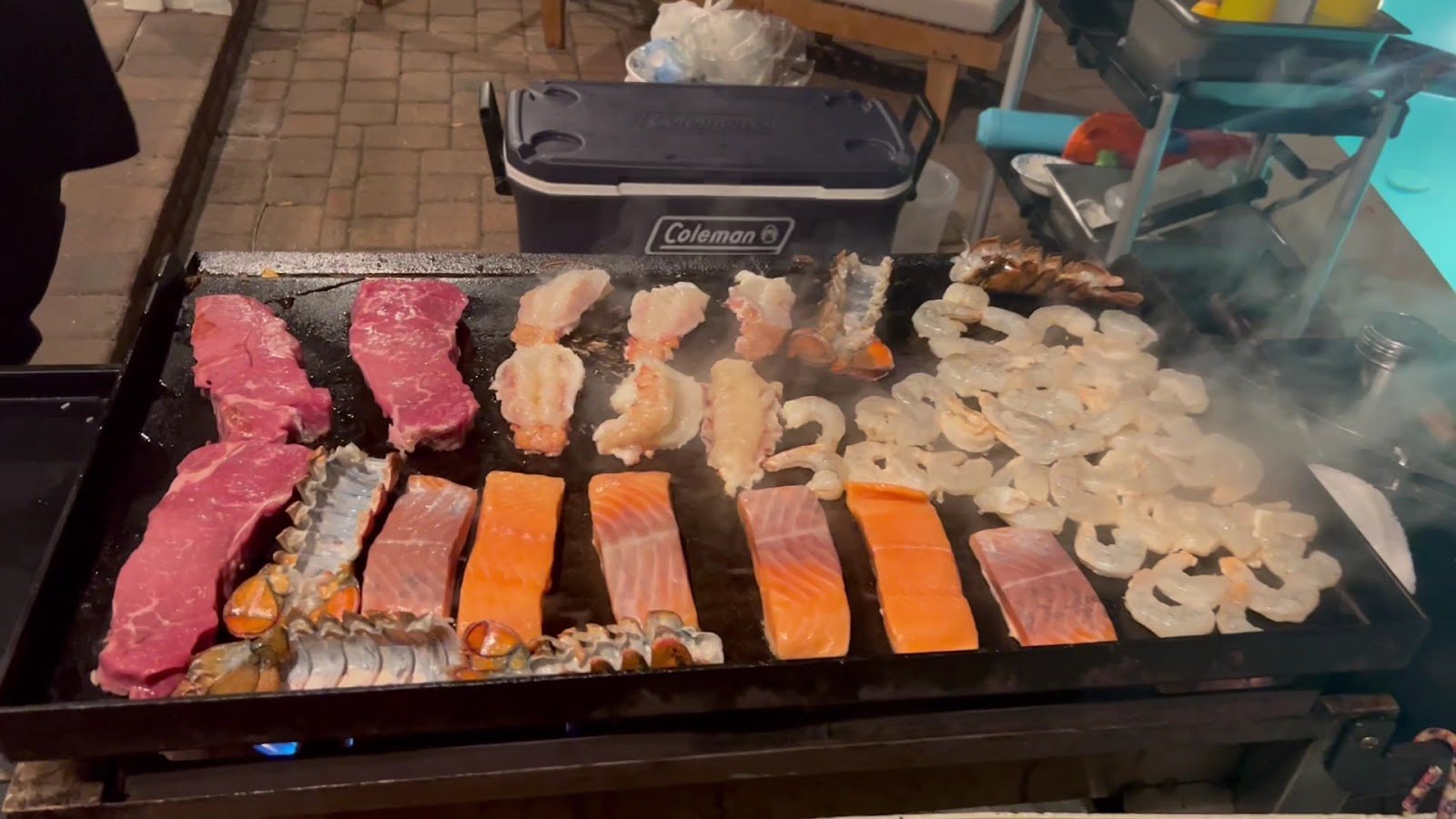 Fresh steak, lobster, salmon, and shrimp grilled to order, hibachi-style, for an Emerald Coast party